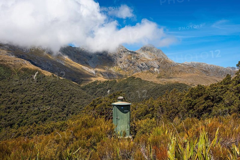 Toilets can be found on many hiking trails in New Zealand. Mountain scenery on the Key Summit Track hiking trail. Fiordland National Park, Southland Region, South Island, New Zealand