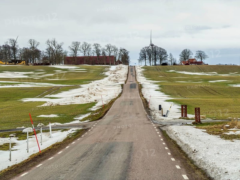 Winter, soon spring. Snowmelt. country road in landscape with melting snow in Ystad municipality, Skåne county, Sweden, Scandinavia
