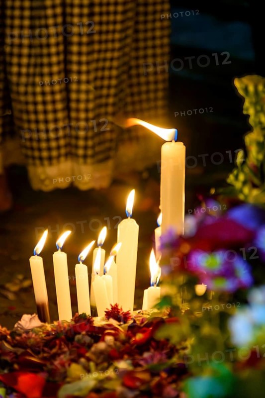 Candles and flowers placed as an offering to the religious entity of Umbanda, Brazil