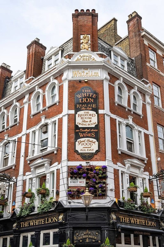 London, United Kingdom. April 9th 2026. The White Lion Pub, a historical public house with a black and gold exterior and traditional wood paneling interior, James Street, Covent Garden, London, UK