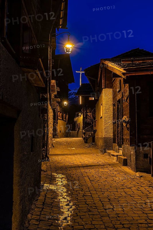 Old illuminated farmhouses in Rue Du Village, night view, historic town center, Grimentz, Val d'Anniviers, Valais Alps, Canton of Valais, Switzerland
