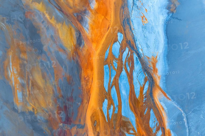 A captivating aerial photograph showcasing a vibrant abstract landscape with flowing forms and a multicolour palette, evoking artistic interpretations