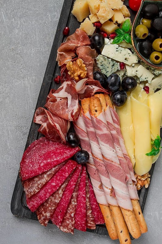 Appetizer, assortment, set, sausage, and cheese, on a wooden board, top view, no people