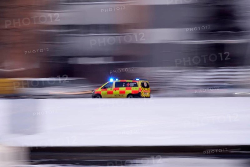 Ambulance on a road, winter, Germany