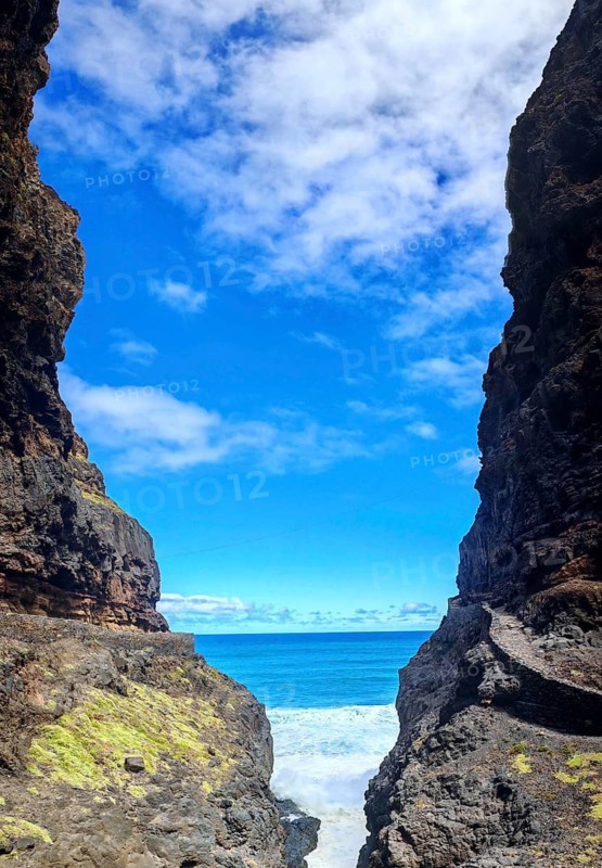 Hiking trail snakes along Narrow Cliff Gorge with views of the blue sea under clear skies, hiking, Marinha da Cruzinha nature park Park, Santo Antao, Cabo Verde, Cape Verde, Cape Verde