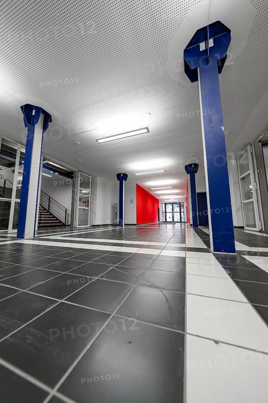 Modern interior with blue columns, red wall and tiled floor, University of Stuttgart, Germany
