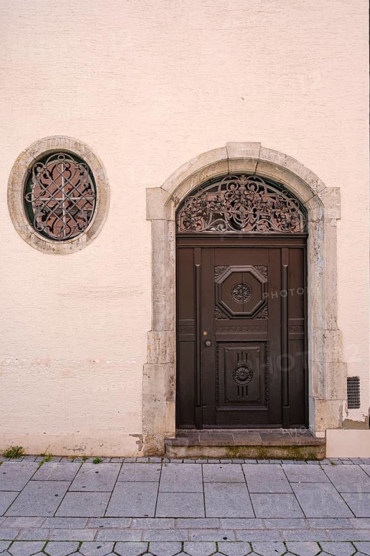 Artfully crafted round-arched door in a historic building on Manghausplatz in the old town of Memmingen in Unterallgäu, Swabia, Bavaria, Germany
