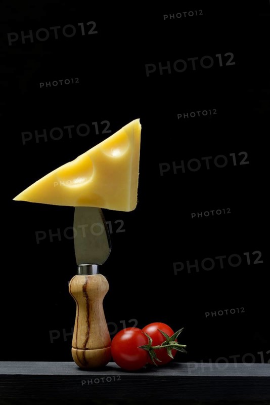 A piece of Swiss Emmental cheese on a cheese knife