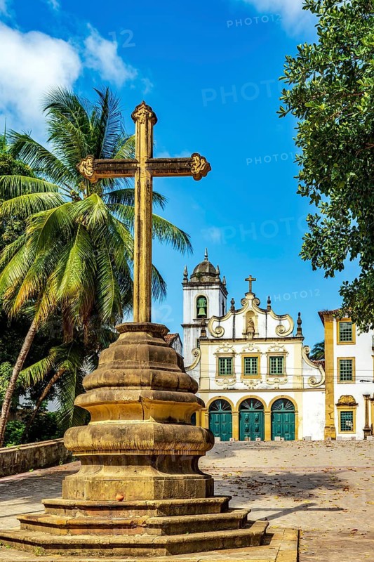 Facade of historic baroque church with stone crucifix in front in Olinda, Pernambuco, Brazil, Olinda, Pernambuco, Brazil