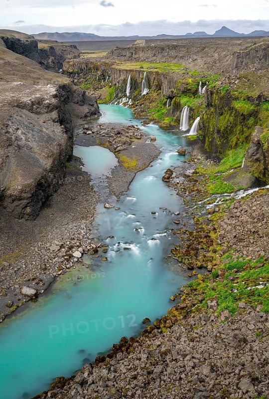 Waterfalls and a turquoise blue river flowing through a canyon, Sigöldugljúfur, long exposure, Icelandic highlands, Iceland