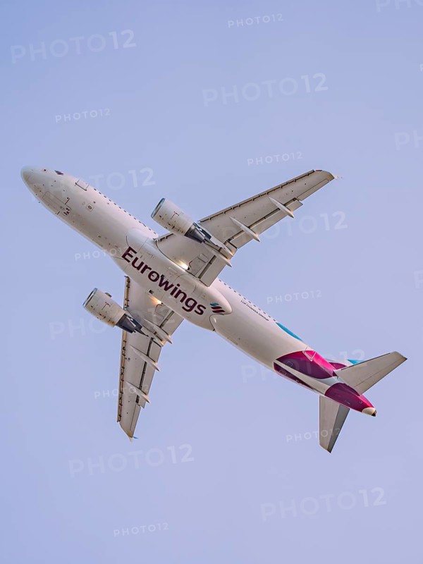 A Eurowings aircraft flies in a clear sky, Stuttgart Airport, Germany