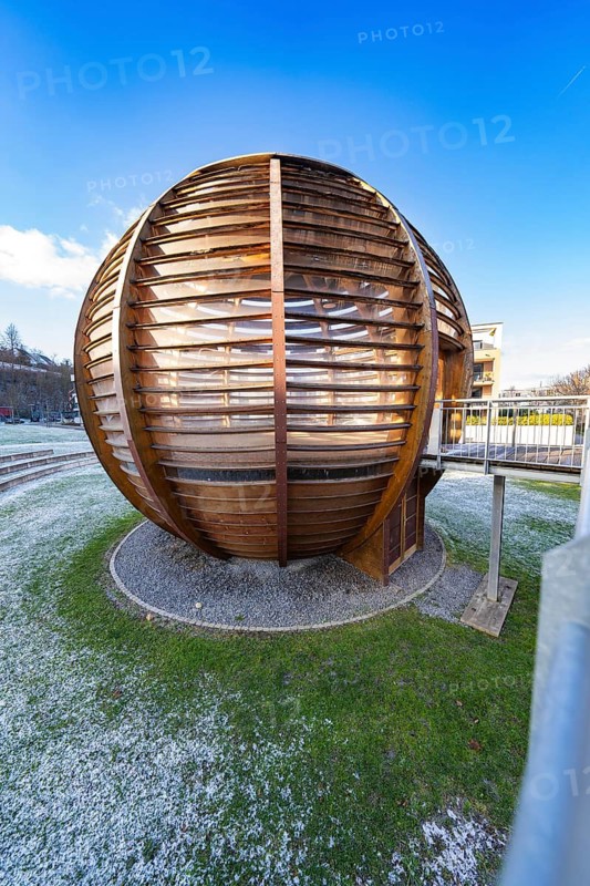 Detailed view of a wooden ball structure in the grass with frosty-snowy ground and blue sky, forest ball from Landesgartenschau 2012, Nagold, Black Forest, Germany