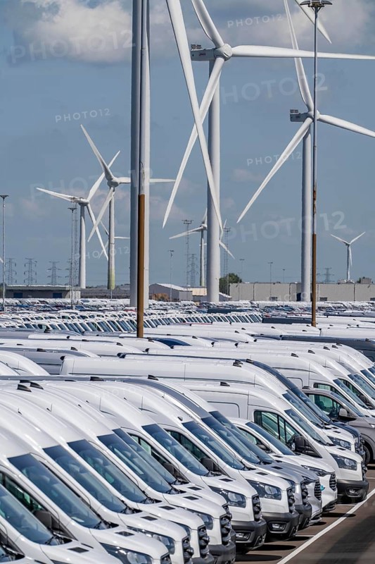 Storage area for new cars in the port of Vlissingen-Oost, vehicles are temporarily stored on over 100 hectares to ship them from Europe to the United Kingdom, Ford cars, others such as models from the Chinese car manufacturer BYD are delivered from here in Europe, wind farm, Netherlands