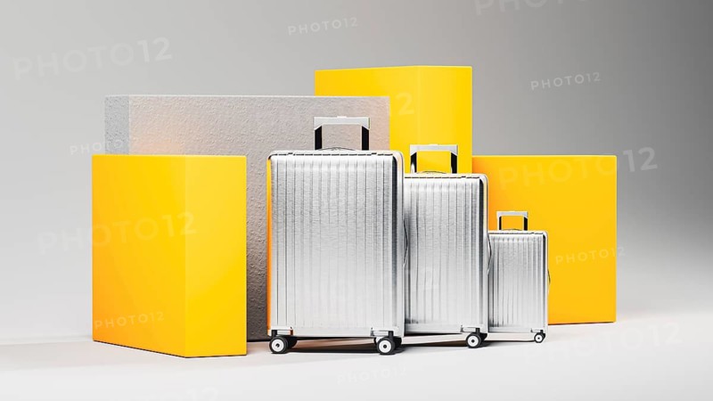 A collection of shining suitcases stands against a neutral backdrop, inviting thoughts of new adventures and exciting journeys to distant places