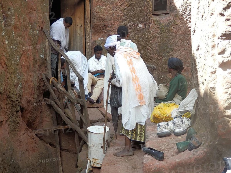 Group of people take off their shoes in front of entering a rock church, UNESCO World Heritage Site, Lalibela Rock Church, Ethiopia