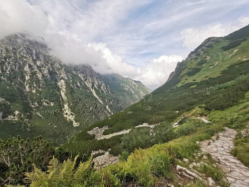 A winding path leads through the impressive mountain landscape, Zakopane, hiking in the High Tatras National Park, Carpathian Mountains, Poland