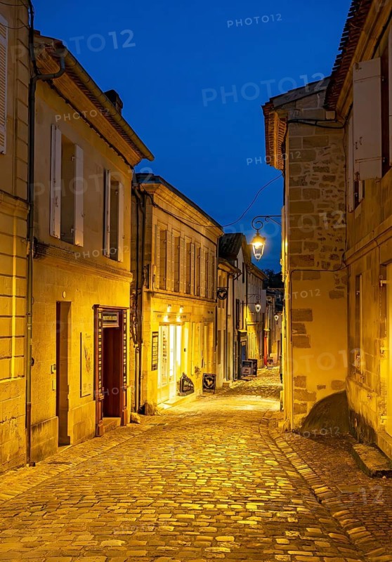 Narrow street in Saint-Emilion by night, France