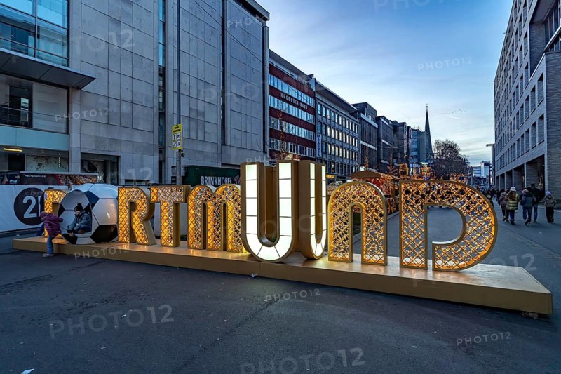 Light installation beer carriage with horses at Dortmund's Christmas market at dusk, Dortmund, North Rhine-Westphalia, Germany