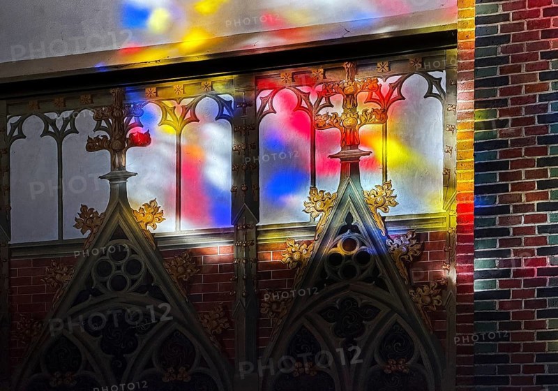 Colored light falls through the stained glass windows in St. Anthony's Church onto a sacred wall painting, interior photo, detail, Papenburg, Emsland, Lower Saxony