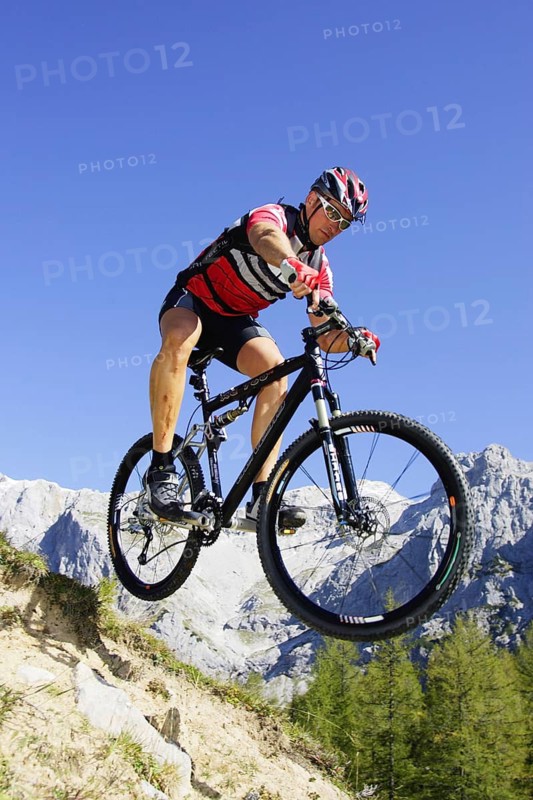 A man on a mountain bike in an alpine landscape