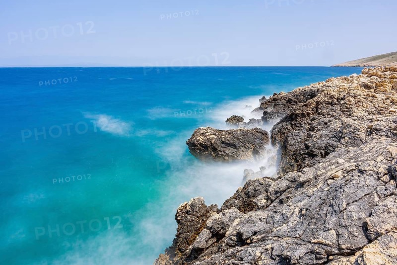 Romantic view over the sea in Koromacna Bay on a sunny day with rough seas on the island of Cres, long exposure, Croatia
