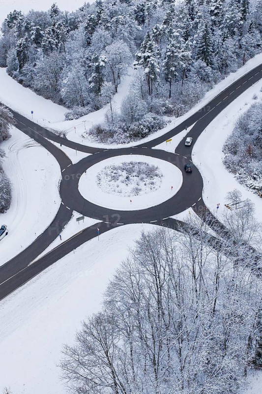 Roundabout, surrounded by snowy trees, from the air, Gechingen, Calw district, Germany