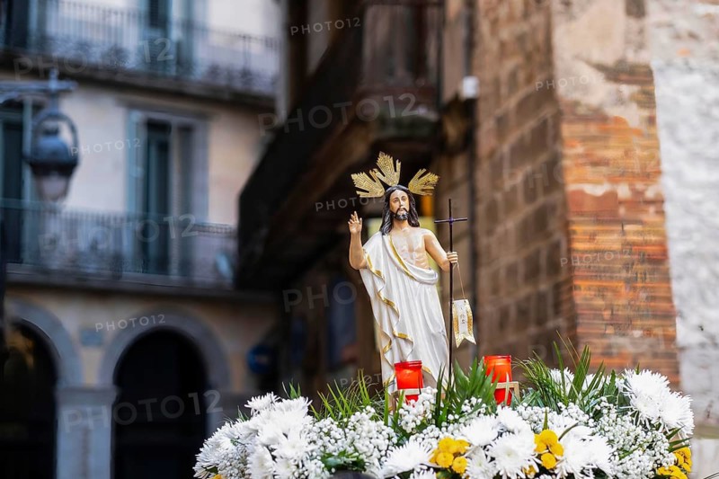 A figure of Jesus is carried through the city centre of Barcelona