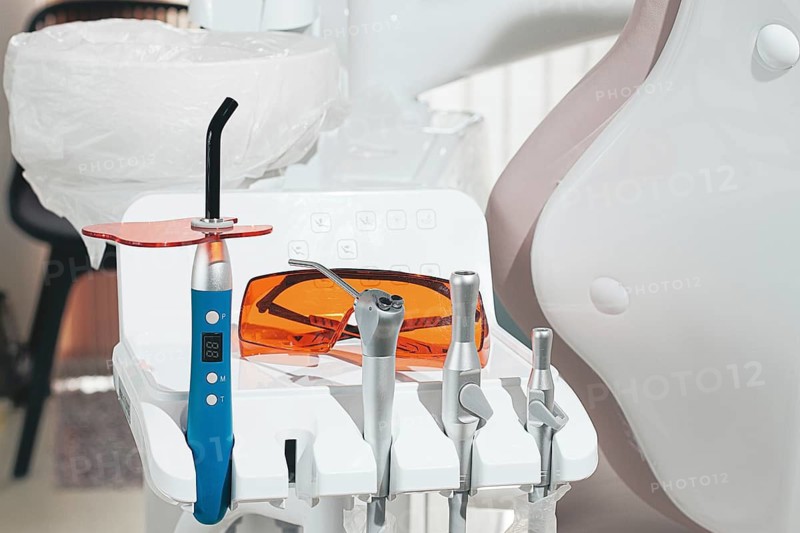 Dental instruments, photopolymer lamp, safety glasses, on a modular table