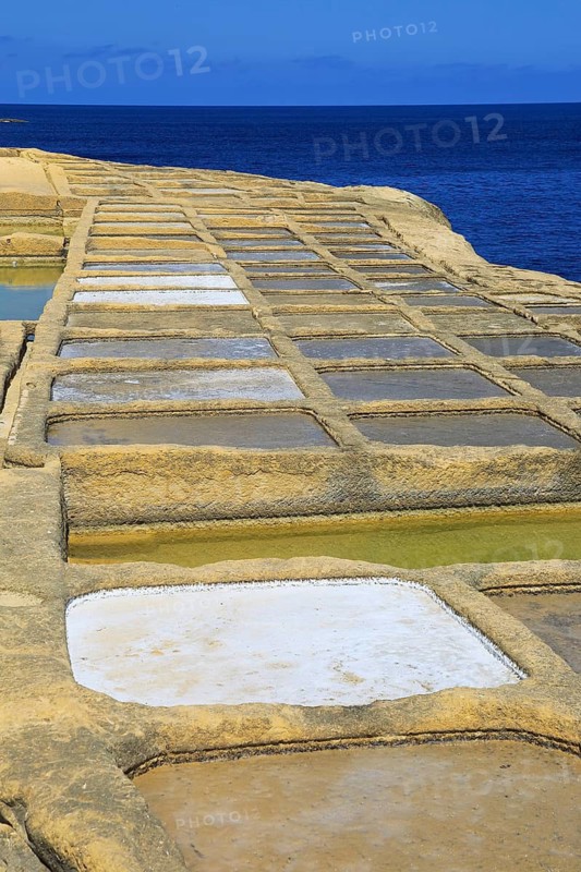 Historic ancient salt pans on coast near Marsalforn, island of Gozo, Malta