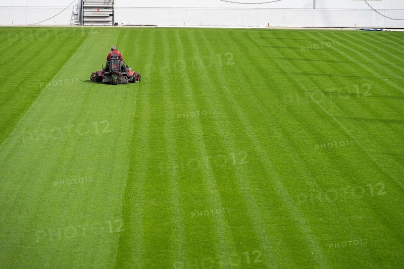 Mowing grass at the football stadium in Lubin, Poland