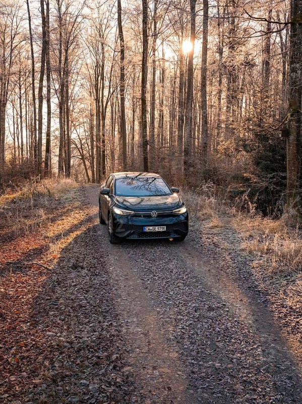 A car on a forest path at sunrise, surrounded by frosty grass, car sharing, electric car, Volkswagen ID 5, Gechingen, Hecken und Gäu region, Black Forest, Germany