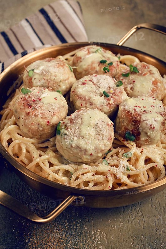 Spaghetti with chicken meatballs, with cream sauce, and parmesan cheese, and decorated with microgreens, homemade, no people