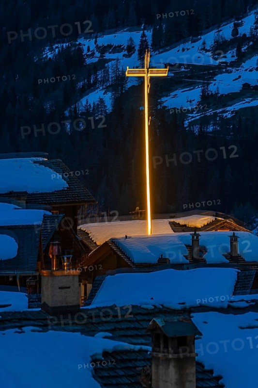 Illuminated cross in wintery Grimentz, Val d'Anniviers, Valais Alps, Canton Valais, Switzerland
