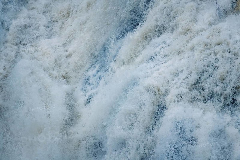 Detailed image capturing the intense, foamy water of Presa del Villar in Madrid. Close-up of turbulent water, typical of long exposure techniques