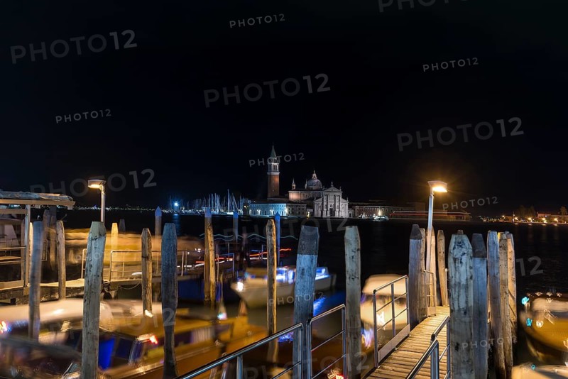 San Marco night-time boat dock, in the back the island of Saint Giorgio Maggiore, Venice, Veneto, Italy
