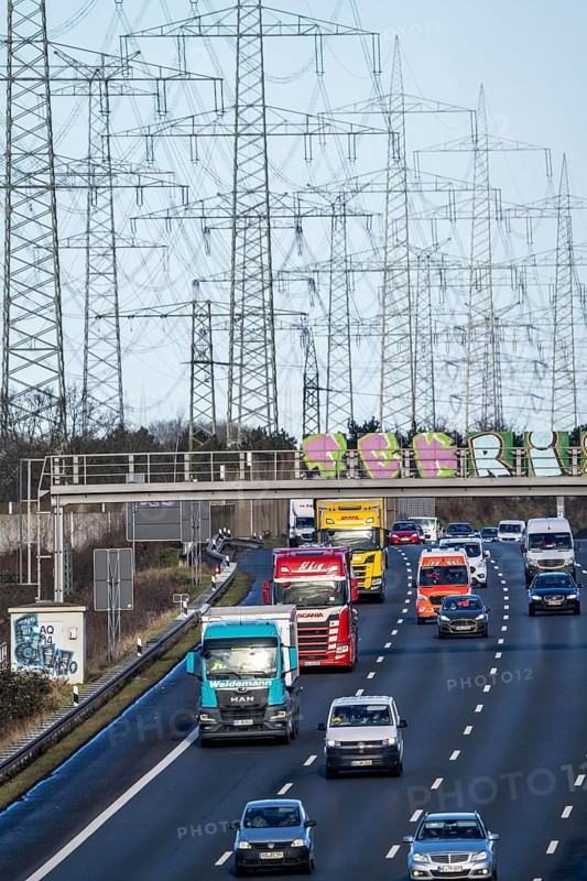 A57 motorway near Kaarst in the Rhine district of Neuss, view in the direction of the Kaarst motorway junction, heavy traffic, overhead power lines, along the motorway, North Rhine-Westphalia, Germany