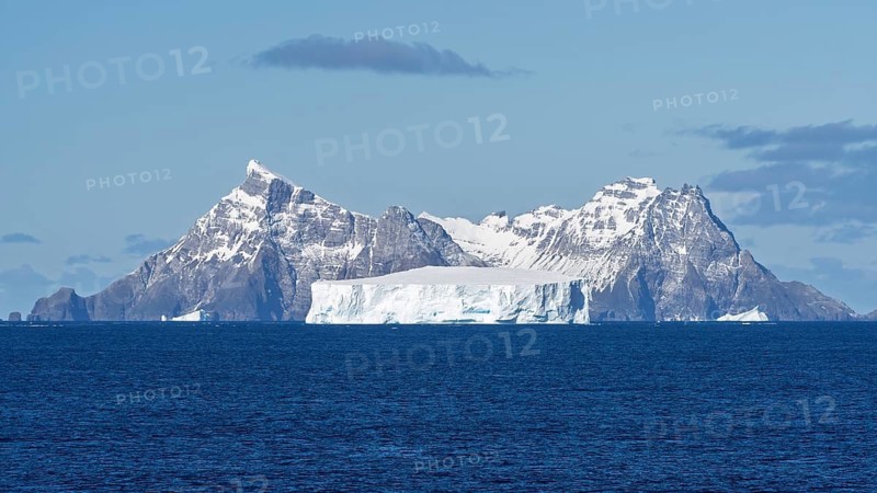 Table iceberg off a snow-covered mountain range in the South Atlantic, coast of South Georgia, South Georgia and the South Sandwich Islands