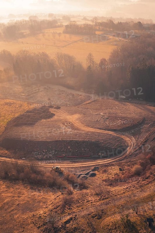 Hilly landscape with fields and trees in autumn light at sunset from the air, landfill, Gechingen, Calw district, Germany