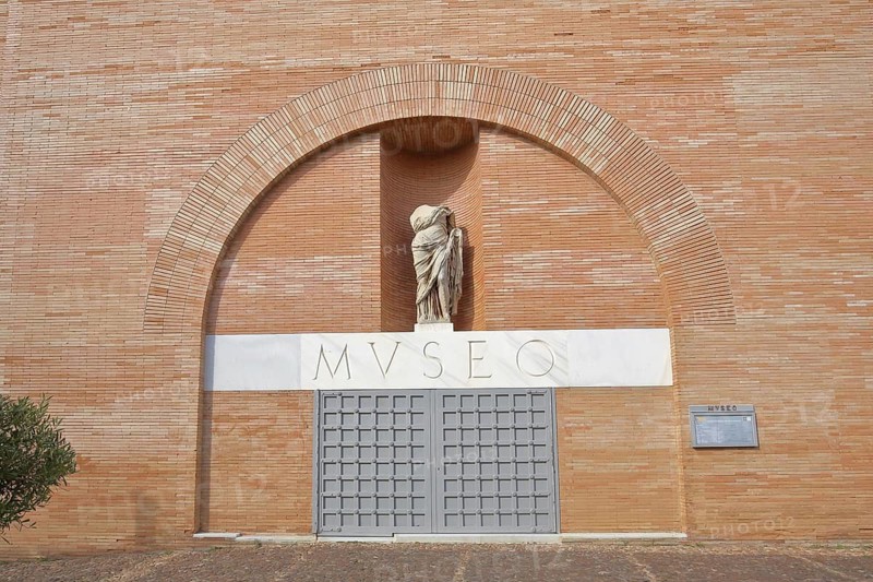 House wall of the Museo Nacional de Arte Romano, National Museum of Roman Art, headless stone sculpture, without, head, inscription, red brick building, Merida, Extremadura, Spain