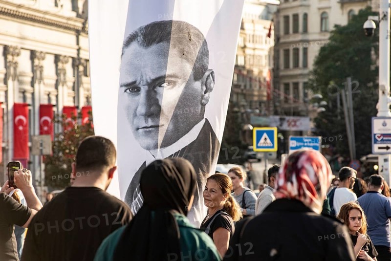 Istanbul, Turkey. October 29th 2023 A woman poses with a portrait of Mustafa Kemal Ataturk in Taksim Square, Istanbul, on the 100th anniversary of the founding of the Republic of Turkey