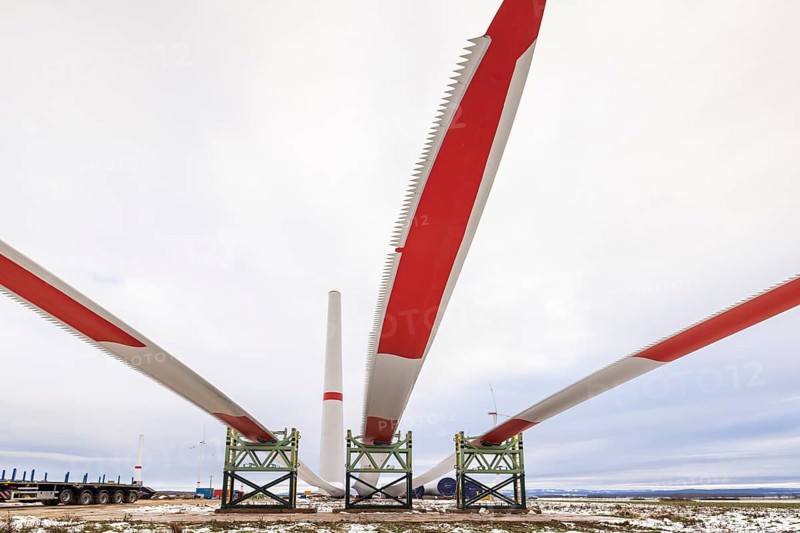 Rotor blades lying in front of the unfinished tower at the Cramme wind farm construction site, Oderwald, Lower Saxony, Germany