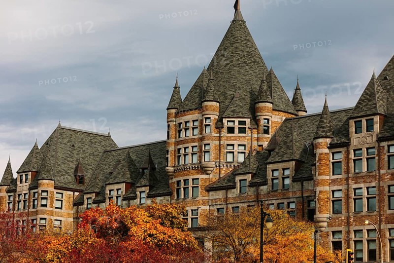 Fall colors complement the historic architecture in Montreal, Quebec, with vibrant leaves and a stunning skyline, showcasing the city's autumn charm and architectural beauty