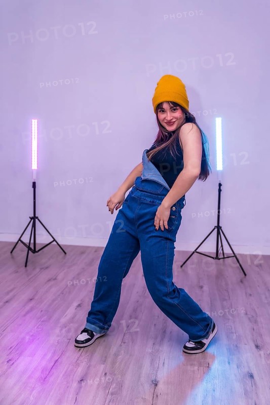 Talented young dancer practicing a modern choreography in a dance academy with led lights