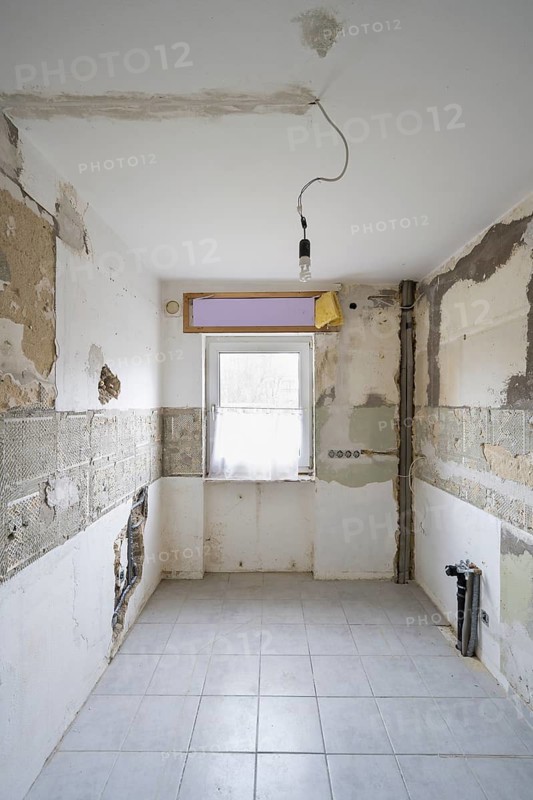 Apartment is being renovated, partly exposed walls, exposed pipes, old building renovation