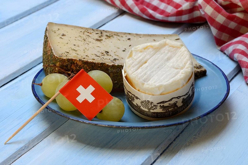 Plate of Swiss cheese, Gstaad mountain cheese with herbs and cream cheese 'Fette Berta', Switzerland