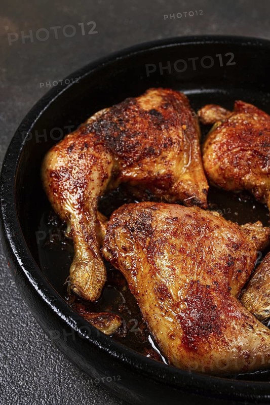 Baked chicken legs, with crispy skin, served in a pan, rustic style, homemade, no people