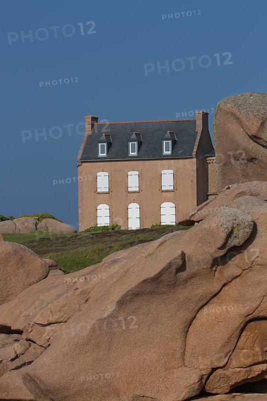 Old house next to Lighthouse Mean Ruz at Ploumanach, Cotes d'Armor in the evening light