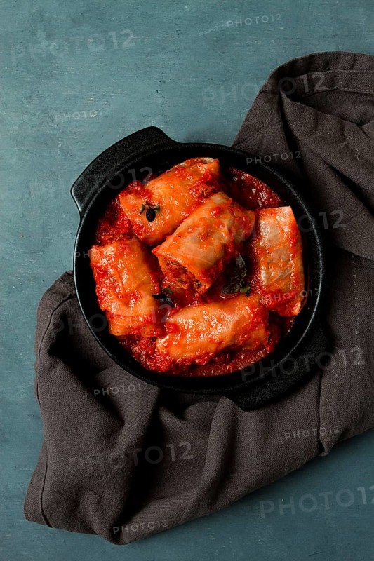Stuffed cabbage rolls in tomato sauce stuffed cabbage leaves, minced meat with rice, on a dark background, top view, no people