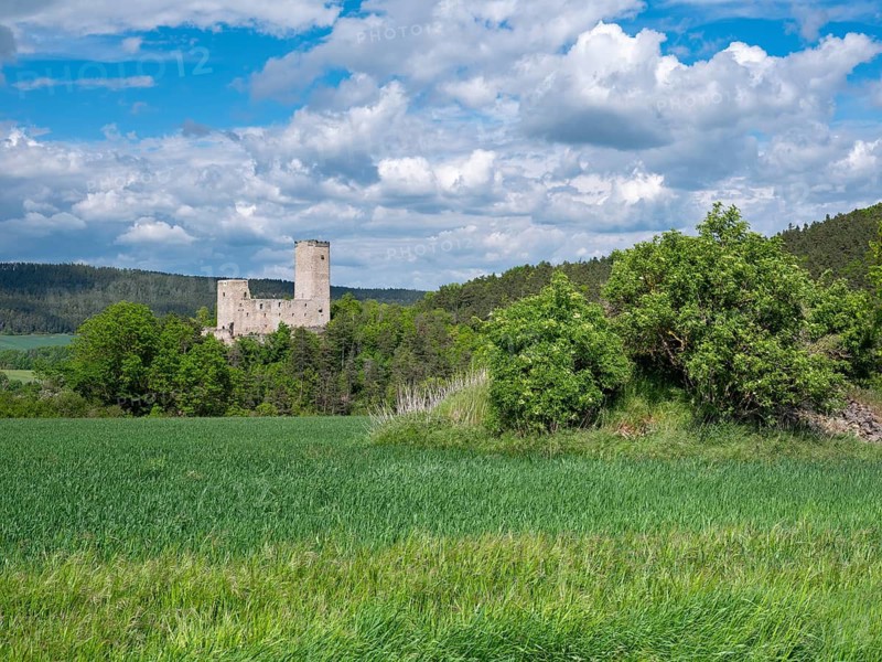 Landscape with the ruins of Ehrenstein Castle under dramatic cloudy sky, Stadtilm, Thuringia, Germany