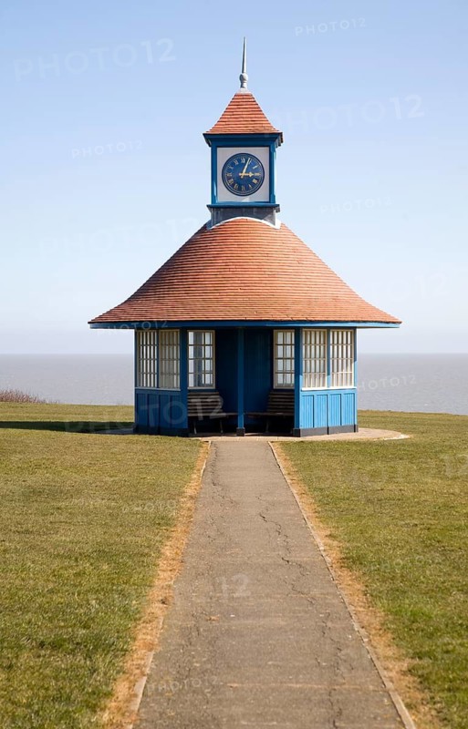 Seaside shelter and clock tower by the sea on the Greensward, Frinton on Sea, Essex, England, United Kingdom